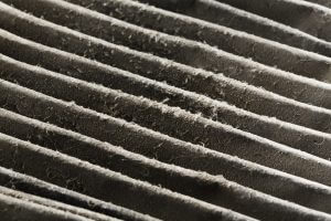 Close up dirty car air conditioner filter isolated on white